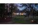 Serene backyard surrounded by trees, with landscape lighting at 8725 Nw 31St Lane Rd, Ocala, FL 34482