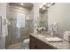Modern bathroom with a large shower, vanity with granite countertop, and neutral tile at 8725 Nw 31St Lane Rd, Ocala, FL 34482