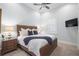 Spacious bedroom with a king-size bed, nightstands, and a large TV at 8725 Nw 31St Lane Rd, Ocala, FL 34482