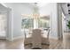 Bright breakfast nook with a round table and chairs, offering a view of the pool at 8725 Nw 31St Lane Rd, Ocala, FL 34482