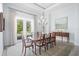 Elegant dining room with a wood table, chairs, and access to the backyard at 8725 Nw 31St Lane Rd, Ocala, FL 34482