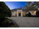 Elegant single-story home with a tile roof and a large driveway at 8725 Nw 31St Lane Rd, Ocala, FL 34482