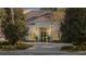 Elegant home with a white exterior, paver driveway, and lush landscaping at 8725 Nw 31St Lane Rd, Ocala, FL 34482