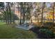Charming fire pit area surrounded by lush landscaping and trees at 8725 Nw 31St Lane Rd, Ocala, FL 34482