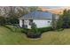 House exterior showcasing landscaping and a private backyard at 8725 Nw 31St Lane Rd, Ocala, FL 34482