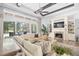 Spacious living room with a fireplace, large windows, and comfortable seating at 8725 Nw 31St Lane Rd, Ocala, FL 34482