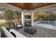 Relaxing covered patio with fireplace, pool view, and comfortable seating area at 8725 Nw 31St Lane Rd, Ocala, FL 34482