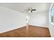 Simple bedroom featuring wood floors and a ceiling fan at 10962 Sw 81St Ave, Ocala, FL 34481
