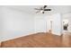 Bedroom with wood floors, ceiling fan and access to bathroom and kitchen at 10962 Sw 81St Ave, Ocala, FL 34481