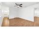 Spacious bedroom with wood floors, ceiling fan, and adjacent bathroom at 10962 Sw 81St Ave, Ocala, FL 34481