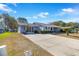 House exterior with a long driveway and palm trees at 10962 Sw 81St Ave, Ocala, FL 34481