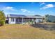 View of house exterior showcasing solar panels and screened porch at 10962 Sw 81St Ave, Ocala, FL 34481