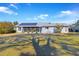 Rear view of the house showing solar panels and screened porch at 10962 Sw 81St Ave, Ocala, FL 34481