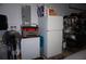 Garage with refrigerator, shelving, and fan at 13091 Sw 77Th Ct, Ocala, FL 34473