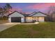 White farmhouse exterior with a black roof and wood accents at 13516 Sw 80Th St, Dunnellon, FL 34432