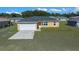 Single-story house with attached garage and light-tan exterior at 13657 Sw 113Th Pl, Dunnellon, FL 34432