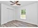 Bright bedroom with double door closet and wood-look flooring at 19925 Sw Lark Dr, Dunnellon, FL 34431