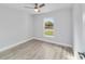 Simple bedroom with wood-look flooring and large window at 2391 Sw 143 Ct, Ocala, FL 34481