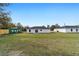 Back view of a white house with a grassy yard at 2391 Sw 143 Ct, Ocala, FL 34481