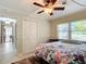 Well-lit bedroom with ceiling fan and double closet at 4911 Ne 13Th St, Ocala, FL 34470