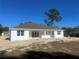New construction home showcasing the back exterior and surrounding landscape at 5912 Ne 57Th N Loop, Silver Springs, FL 34488