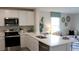 Modern kitchen with white cabinets and an island at 6606 Sw 81St Loop, Ocala, FL 34476