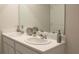 Double vanity bathroom with modern fixtures and a large mirror at 6614 Sw 81St Loop, Ocala, FL 34476