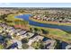 Aerial view of houses, golf course, and lake in a residential community at 6671 Sw 97Th Terrace Rd, Ocala, FL 34481