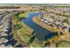 Aerial view of houses and a lake in a residential community at 6671 Sw 97Th Terrace Rd, Ocala, FL 34481