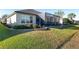Landscaped backyard with screened patio and retaining wall at 6671 Sw 97Th Terrace Rd, Ocala, FL 34481