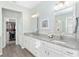 Bathroom with double vanity and walk-in closet access at 6671 Sw 97Th Terrace Rd, Ocala, FL 34481
