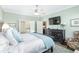 Bright bedroom with a king-size bed and ensuite access at 6671 Sw 97Th Terrace Rd, Ocala, FL 34481