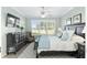 Spacious bedroom with a king-size bed, dresser, and window seat at 6671 Sw 97Th Terrace Rd, Ocala, FL 34481