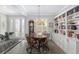 Elegant dining area with a round table, built-in bookcases, and a chandelier at 6671 Sw 97Th Terrace Rd, Ocala, FL 34481