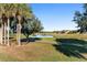 Scenic golf course view with palm trees and pond at 6671 Sw 97Th Terrace Rd, Ocala, FL 34481