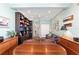 Home office with a round table, built-in shelving, and comfortable seating at 6671 Sw 97Th Terrace Rd, Ocala, FL 34481