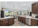 Open kitchen with island, granite counters, and stainless steel appliances at 6671 Sw 97Th Terrace Rd, Ocala, FL 34481