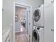 Laundry room with stackable washer and dryer, and a view into the kitchen at 6671 Sw 97Th Terrace Rd, Ocala, FL 34481