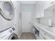 Laundry room with stackable washer and dryer, and white cabinetry at 6671 Sw 97Th Terrace Rd, Ocala, FL 34481