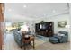 Living room with comfy seating, hardwood floors, and access to patio at 6671 Sw 97Th Terrace Rd, Ocala, FL 34481