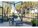 Peaceful screened patio with chaise lounge and picturesque golf course view at 6671 Sw 97Th Terrace Rd, Ocala, FL 34481