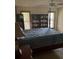 Bedroom with a king-size bed and built-in bookshelves at 8120 Nw 47Th Ln, Ocala, FL 34482