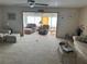 Spacious living room with comfortable seating and a view into a sunroom at 8120 Nw 47Th Ln, Ocala, FL 34482