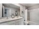 Bathroom with double vanity, shower, and white cabinets at 8469 Las Palmas Way, Wildwood, FL 34785