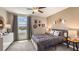 Spacious bedroom with a metal bed frame and geometric accents at 8469 Las Palmas Way, Wildwood, FL 34785