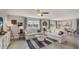 Spacious living room with two sofas, large windows, and view of a lake at 8469 Las Palmas Way, Wildwood, FL 34785