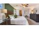 Main bedroom with a large bed and a view of the backyard at 8469 Las Palmas Way, Wildwood, FL 34785
