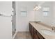 Double vanity bathroom with walk-in shower, grab bars, and tile flooring at 9350 Sw 91St Court Rd, Ocala, FL 34481