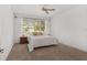 Bright bedroom with carpeted floor, ceiling fan, and golf course view at 9350 Sw 91St Court Rd, Ocala, FL 34481