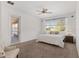 Spacious bedroom with sliding door access to patio, ceiling fan, and ample natural light at 9350 Sw 91St Court Rd, Ocala, FL 34481